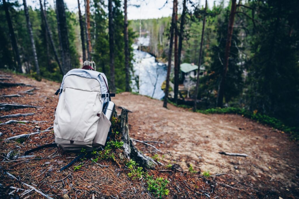 Tourist Backpack of hiker on ground in fall forest in Finland